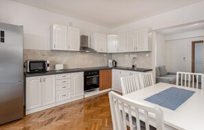 Fridge, stovetop, dishwasher, coffee/tea maker