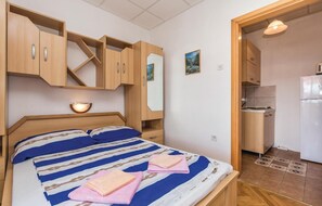 Cozy retreat with a comfortable bed, compact kitchenette, and modern amenities.