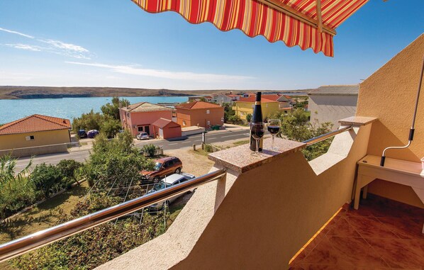 Enjoy breathtaking views of the coastal town from this balcony.