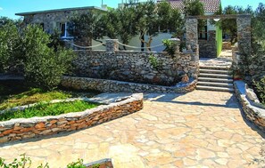 Stroll through the beautifully maintained gardens and approach the entrance of this charming building.