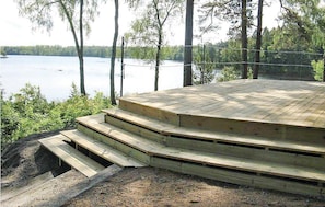 A wooden deck with steps leading to a viewing platform overlooking a lake, surrounded by trees. - Lovely home in Skånes Fagerhult (Skånes Fagerhult)