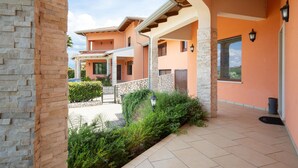 A multi-story residential building with a stone facade, a covered patio area, and a view of the surrounding landscape. - Beautiful home in Rende -CS- with WiFi (Rende -CS-)
