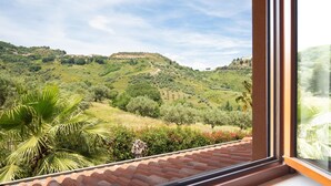 A view from a window overlooking a hilly landscape with greenery and a distant building. - Beautiful home in Rende -CS- with WiFi (Rende -CS-)