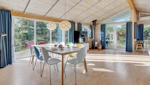 A spacious dining area with a large table and chairs, a television, and a fireplace. - Lovely home in Rømø with WiFi (Rømø)