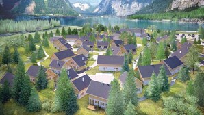 A residential area with houses surrounded by trees and a lake.