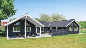 A modern two-story building with a sloped roof and large windows. - Stunning home in Tranekær with sauna (Tranekær)
