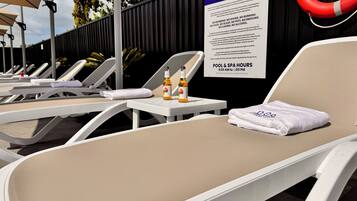 Outdoor pool, open 9:00 AM to 7:00 PM, pool umbrellas, pool loungers