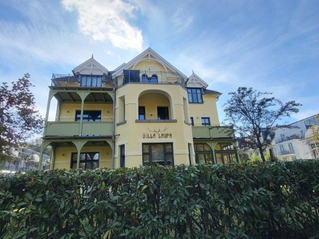 A multi-story building with a prominent arched entrance and balconies.