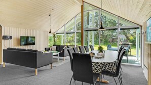 A modern interior with a dining area, a sofa, and a TV. - Awesome home in Væggerløse with kitchen (Væggerløse)