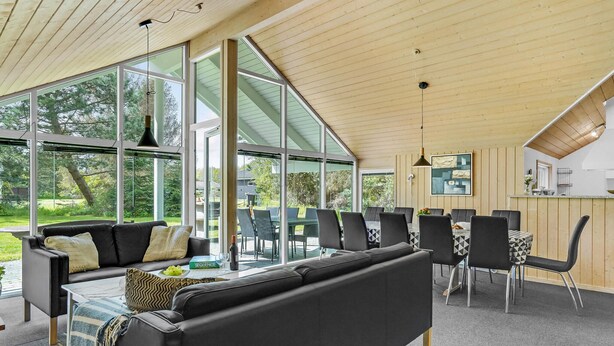 A modern interior with a large open space, a dining area, and a kitchen. - Awesome home in Væggerløse with kitchen (Væggerløse)