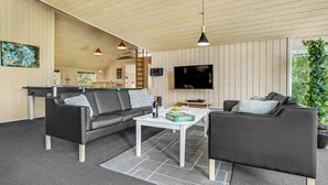 A modern living room with a pool table, two sofas, a coffee table, and a TV. - Awesome home in Væggerløse with kitchen (Væggerløse)