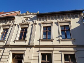 A building with classical architecture, featuring ornate window frames and decorative moldings.