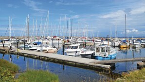 A marina with numerous boats docked along the water's edge. - 3 bedroom beach front home in Højby (Højby)