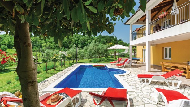 A pool area with lounge chairs, a table, and a covered seating area. - Amazing home in Kranjci (Kranjci)