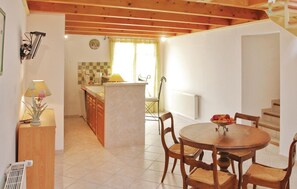 Kitchen area with central island, dining table, and oven.