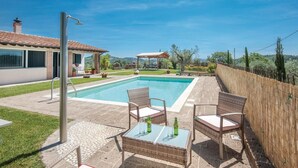 A swimming pool with a pergola and outdoor seating area. - Nice home in Caldana -GR- (Caldana -GR-)