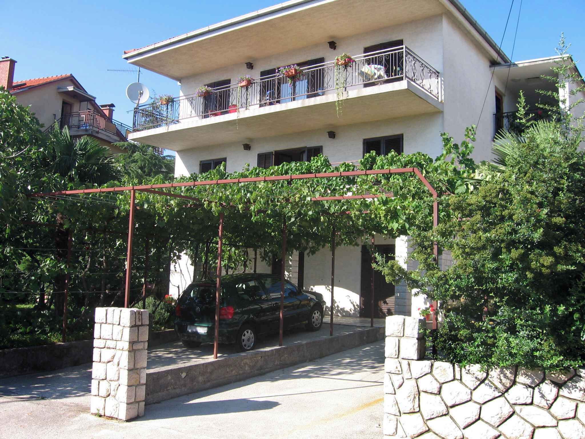 A two-story building with a balcony on the upper floor.