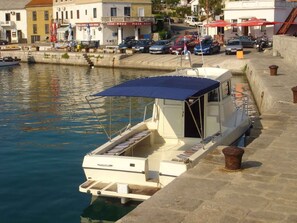 Moored at the marina, this boat offers a convenient seating area for relaxation.