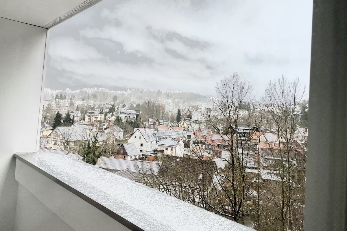 A snowy landscape with buildings and trees.