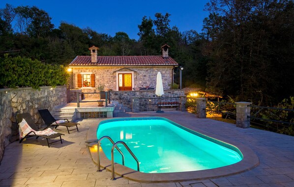 Relax by the pool surrounded by lush greenery and lounge in style.