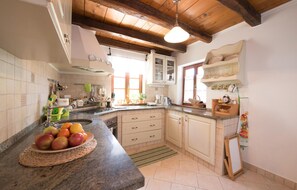 Enjoy cooking in this well-equipped kitchen with a sink, coffee maker, and ample cookware.