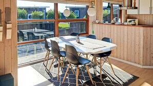 A modern dining area with a large table, chairs, and a view of the outdoors. - Gorgeous home in Sydals with sauna (Sydals)