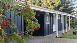 A covered outdoor area with a wooden deck, a door, and a window. - Pet friendly home in Væggerløse with sauna (Væggerløse)