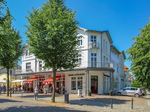 A multi-story building with a ground-floor shop and upper residential or office spaces.
