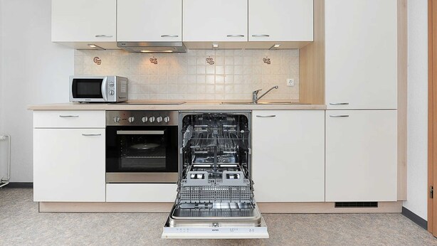 A kitchen with white cabinets, a microwave, an oven, and a dishwasher. - Steering Wheel 2 - Apartments House Steering Wheel (Esens)