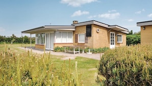 A modern two-story house with a covered patio and a well-maintained lawn. - 3 bedroom awesome home in Faaborg (Faaborg)