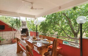 Enjoy al fresco dining in this cozy outdoor space, complete with a fireplace and a table for two.