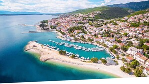 A coastal town with a marina, residential buildings, and a beach. - Holiday apartment 100 m from the beach (Crikvenica)