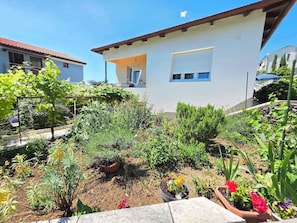 A residential building with a garden in front.