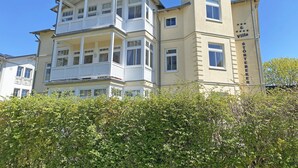 A multi-story hotel with balconies, a prominent tower, and a sign reading "Störtebeker Villa." - Villa Störtebeker Whg. 08 - Villa Störtebeker Whg. 08 (Göhren)