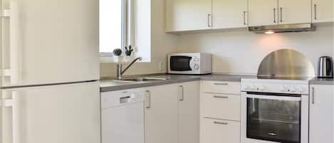 Fridge, stovetop, dishwasher, coffee/tea maker