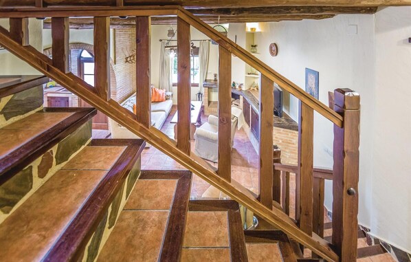 A wooden staircase with a view of a living room area. - Gorgeous home in Montecorto, Málaga (Montecorto, Málaga)