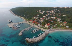 Stunning coastal town with a marina, picturesque houses, and lush greenery.