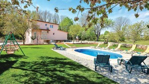 A backyard with a swimming pool, lounge chairs, and a swing set. - Amazing home in Lecevica (Lecevica)