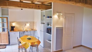 A compact kitchen with a dining table, chairs, a refrigerator, and a microwave. - Amazing home in Minihy Treguier (Minihy Treguier)