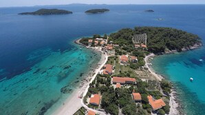 An aerial view of a coastal village with houses, a beach, and clear blue waters. - Beautiful home in Prizba (Prizba)