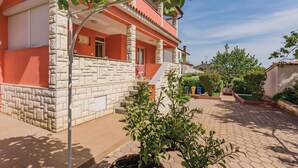 A two-story building with a stone facade and a red upper section. - 1 bedroom gorgeous apartment in Rovinj (Rovinj)