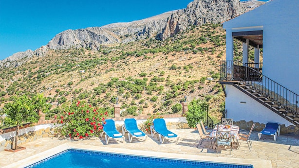 A pool area with lounge chairs, a table, and a staircase leading to a balcony overlooking a mountainous landscape. - Gorgeous home in Alora-El Chorro (Alora-El Chorro)