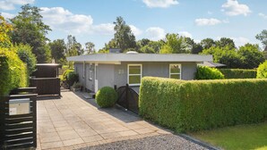 A modern two-story house with a grey exterior, numbered 23, featuring a front door, windows, and a small porch area. - Amazing home in Rudkøbing with WiFi (Rudkøbing)