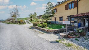 A rural road leading to a yellow building with stone walls and a mailbox. - 3 bedroom cozy home in Marsaglia CN (Marsaglia CN)