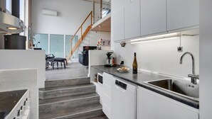A modern kitchen with white cabinetry, a stainless steel sink, and a built-in dishwasher. - Awesome home in Ebeltoft with sauna (Ebeltoft)