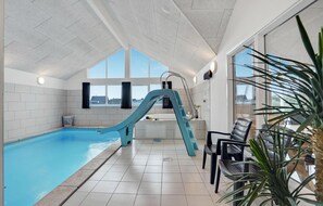 Swim and relax by the pool, surrounded by expansive views of the outside.