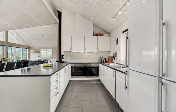 Kitchen features a large island with a sink and ample counter space.
