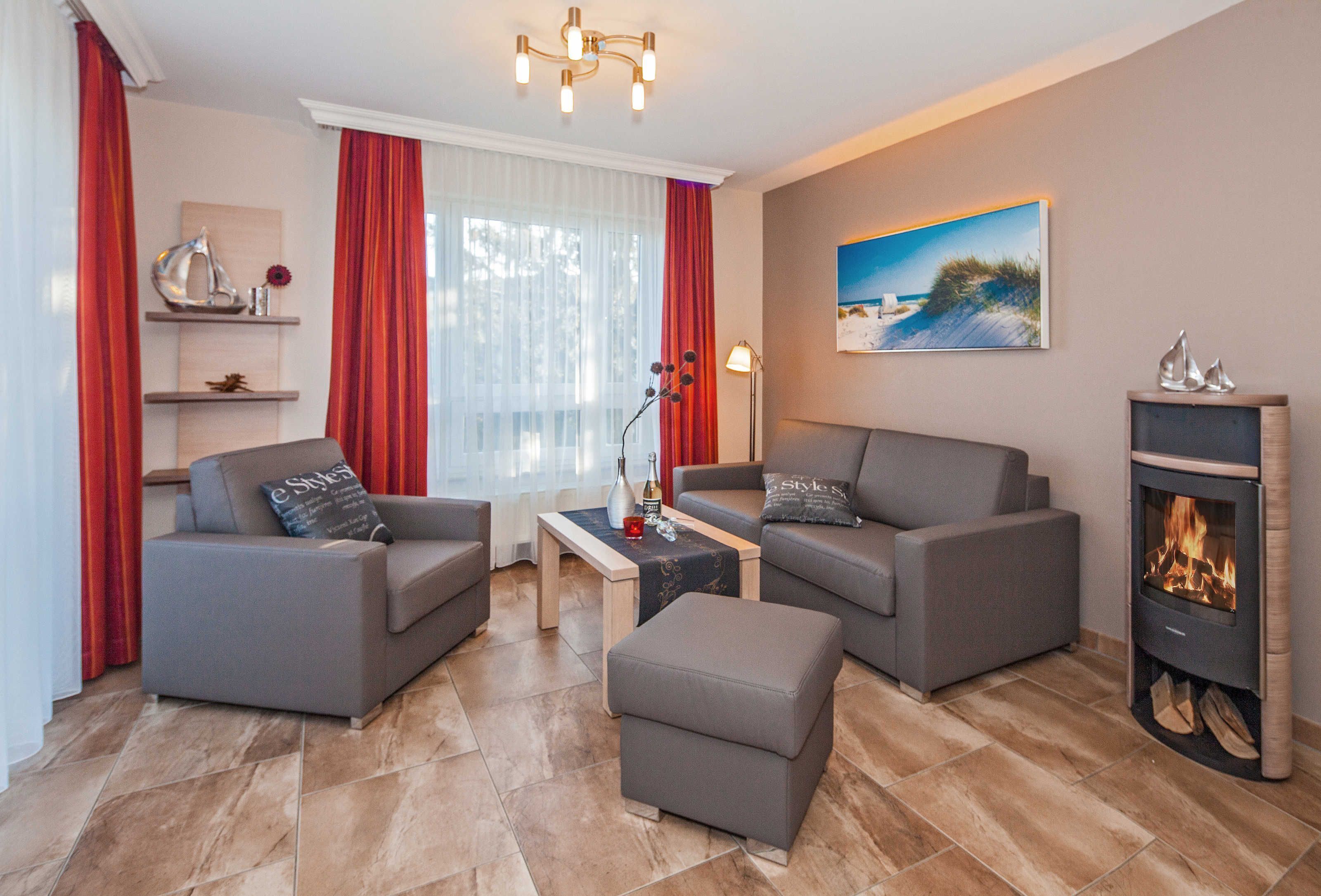 A modern living room with two grey sofas, a small coffee table, and a fireplace.