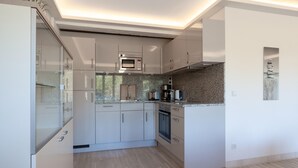 A modern kitchen with built-in appliances, a granite countertop, and a minimalist design. - Gorgeous apartment in Binz with indoor swimming pool (Prora/Rügen)