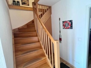 A wooden staircase with a handrail leading to an upper floor. - Zempin Ostseepark WE 34 Island Usedom only 150m to the beach - WE 34 (Zempin)